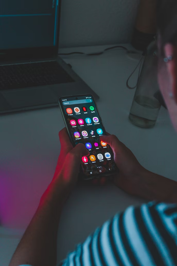 Young user scrolling social media apps, including Instagram and TikTok