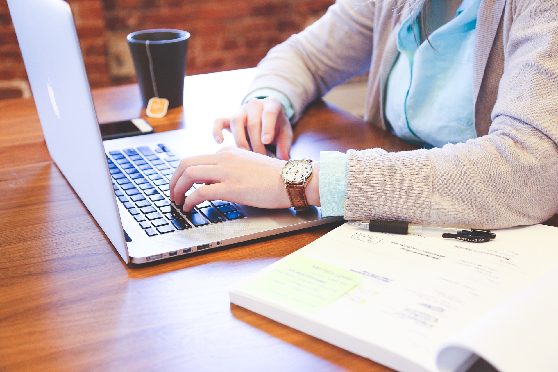 copywriter typing on a laptop